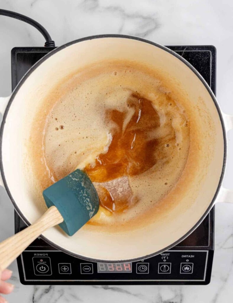 Once the butter is browned, add the mini marshmallows and salt. Stir continuously until the marshmallows are completely melted and the mixture is smooth.