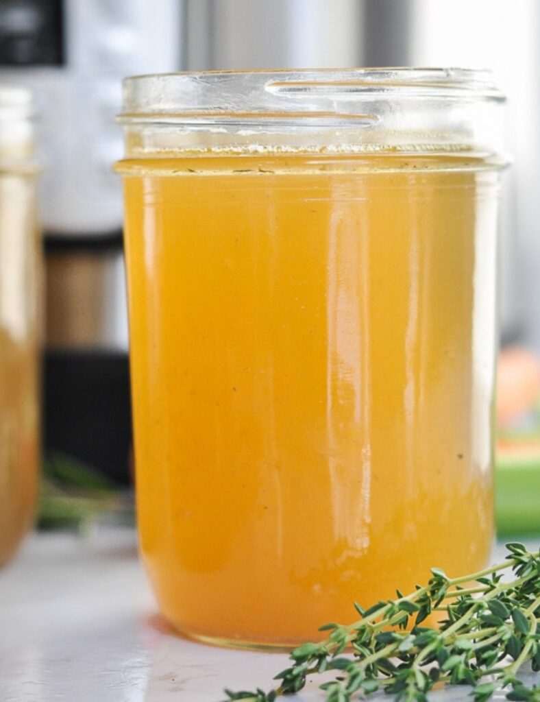 Delicious Instant Pot bone broth in a bowl with herbs and spices