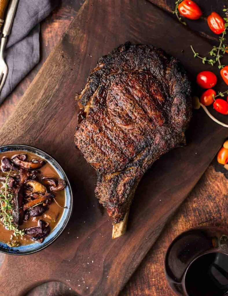 Juicy grilled Cowboy Ribeye Steak served on a plate