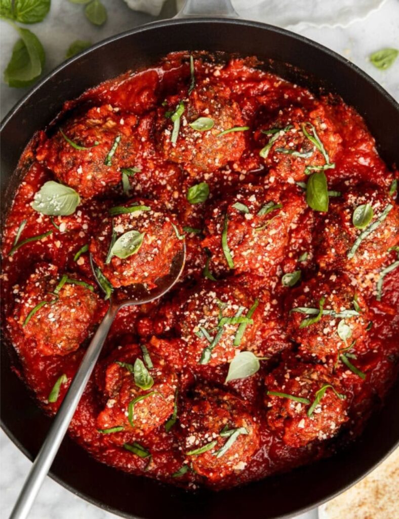 Delicious baked Italian meatballs served on a wooden platter