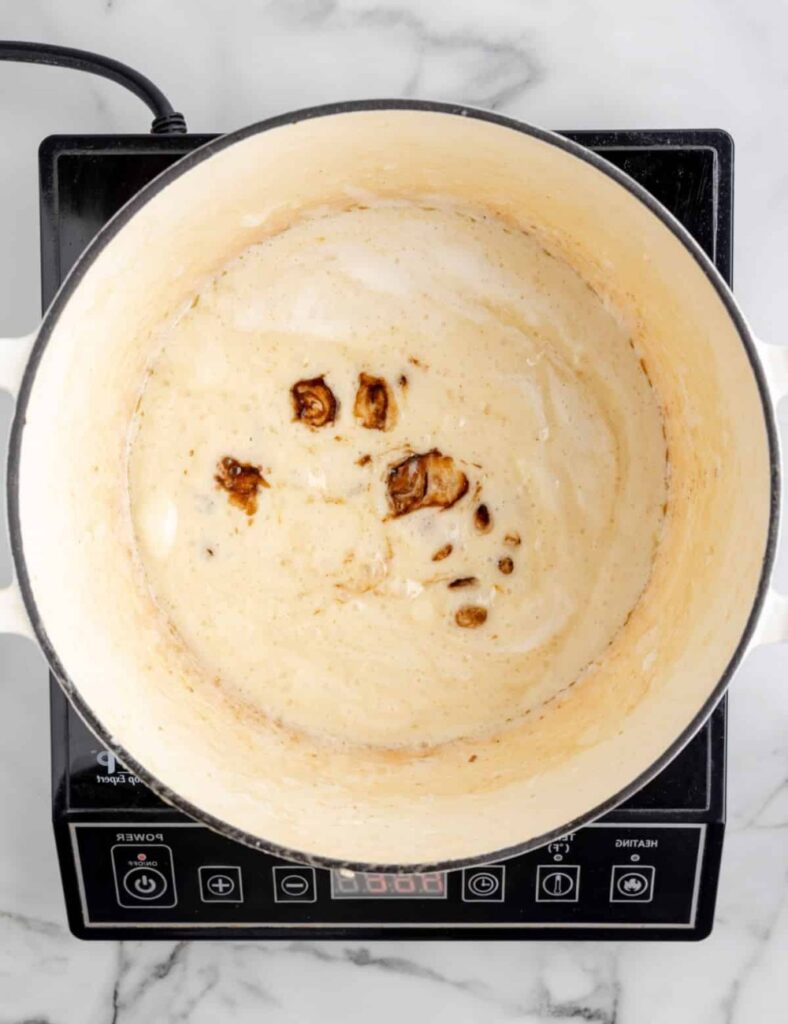 Once the butter is browned, add the mini marshmallows and salt. Stir continuously until the marshmallows are completely melted and the mixture is smooth.