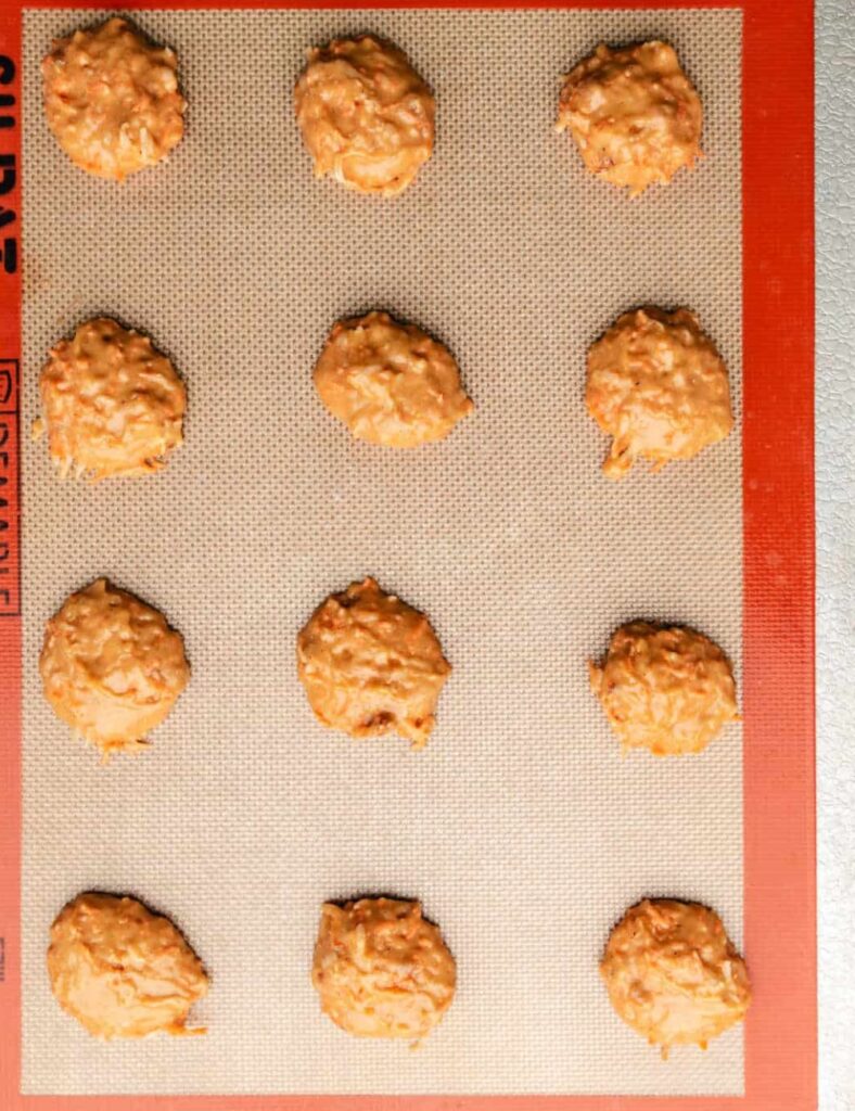 Freshly baked carrot cake cookies with cream cheese frosting and grated carrots