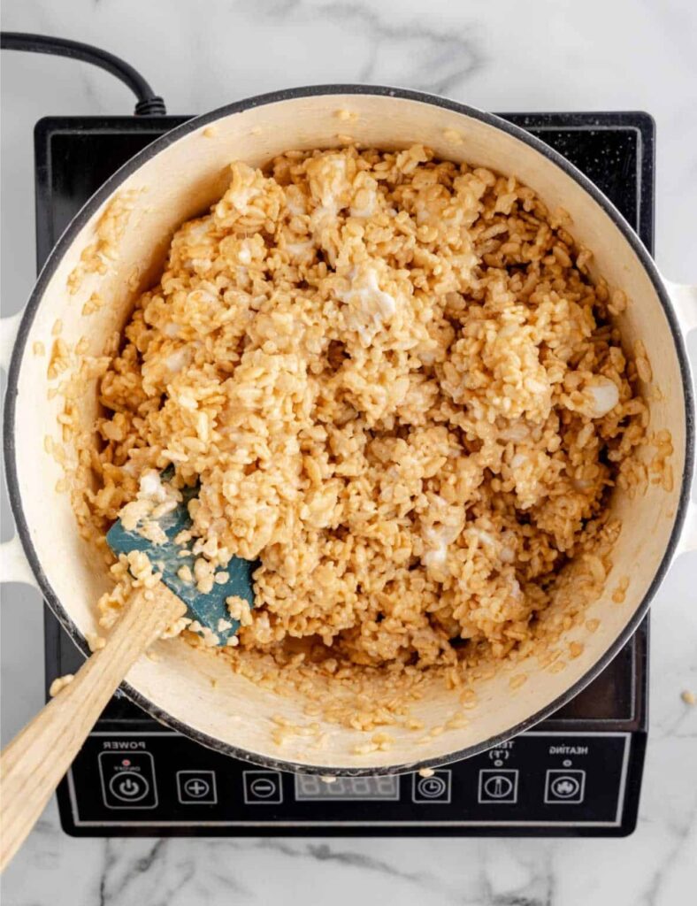 Transfer the mixture into a greased 9x13-inch pan. Using a spatula or your hands (lightly greased), press the mixture evenly into the pan.