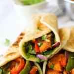 Delicious Chicken Kathi Rolls served with mint chutney and fresh vegetables