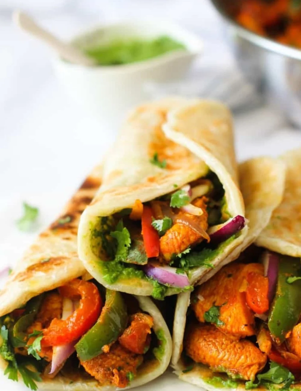 Delicious Chicken Kathi Rolls served with mint chutney and fresh vegetables