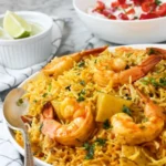 Delicious Instant Pot Shrimp Biryani served in a bowl, garnished with herbs.