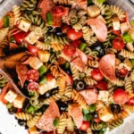 Italian pasta salad with fresh vegetables and dressing in a bowl