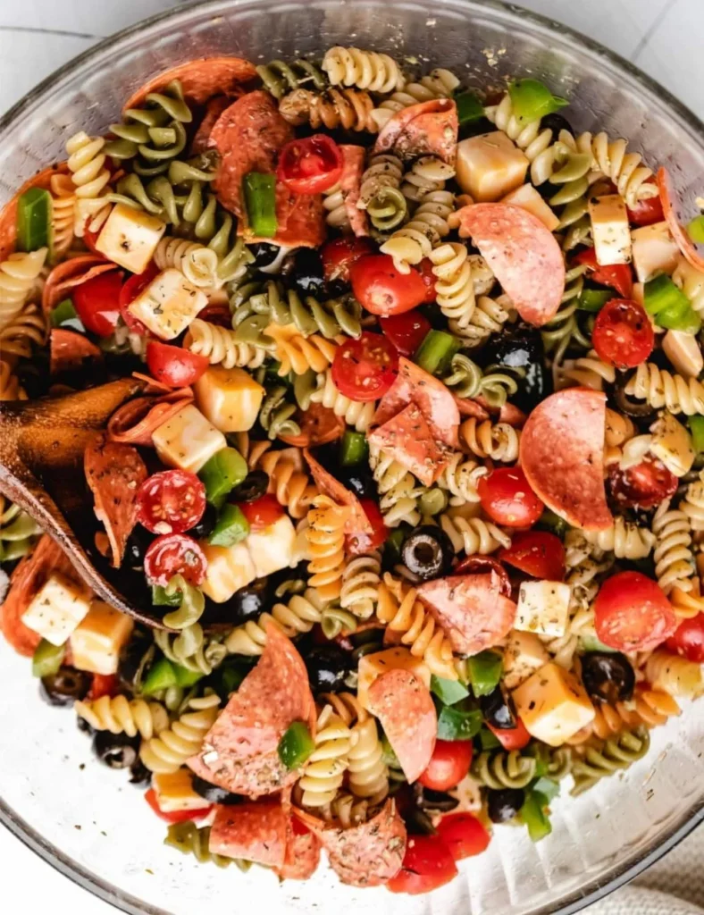 Italian pasta salad with fresh vegetables and dressing in a bowl