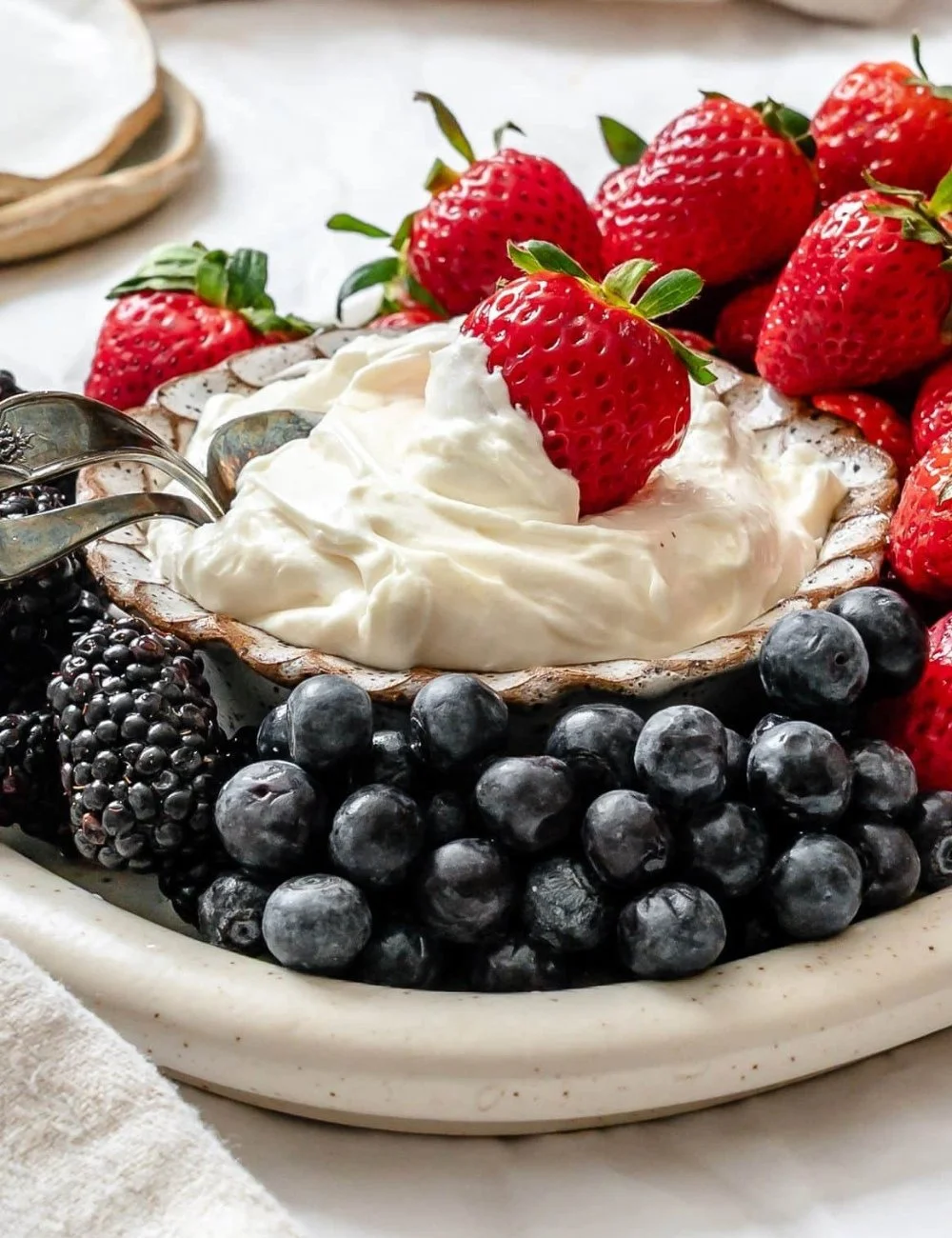 Delicious marshmallow fruit dip served with fresh fruit slices.