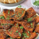 Delicious Masala Karela Fry garnished with spices, served on a plate