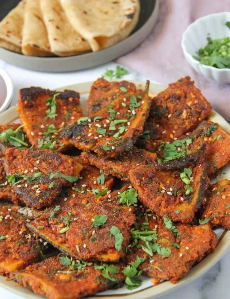 Delicious Masala Karela Fry garnished with spices, served on a plate
