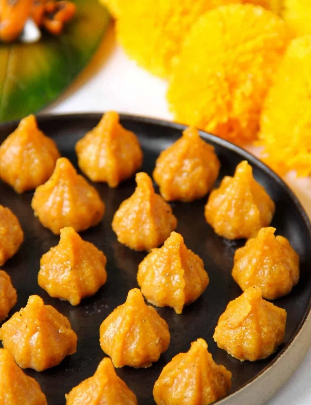 Delicious Mawa Modak sweets served on a traditional platter.