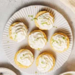 Mini key lime pies with a graham cracker crust and lime garnish