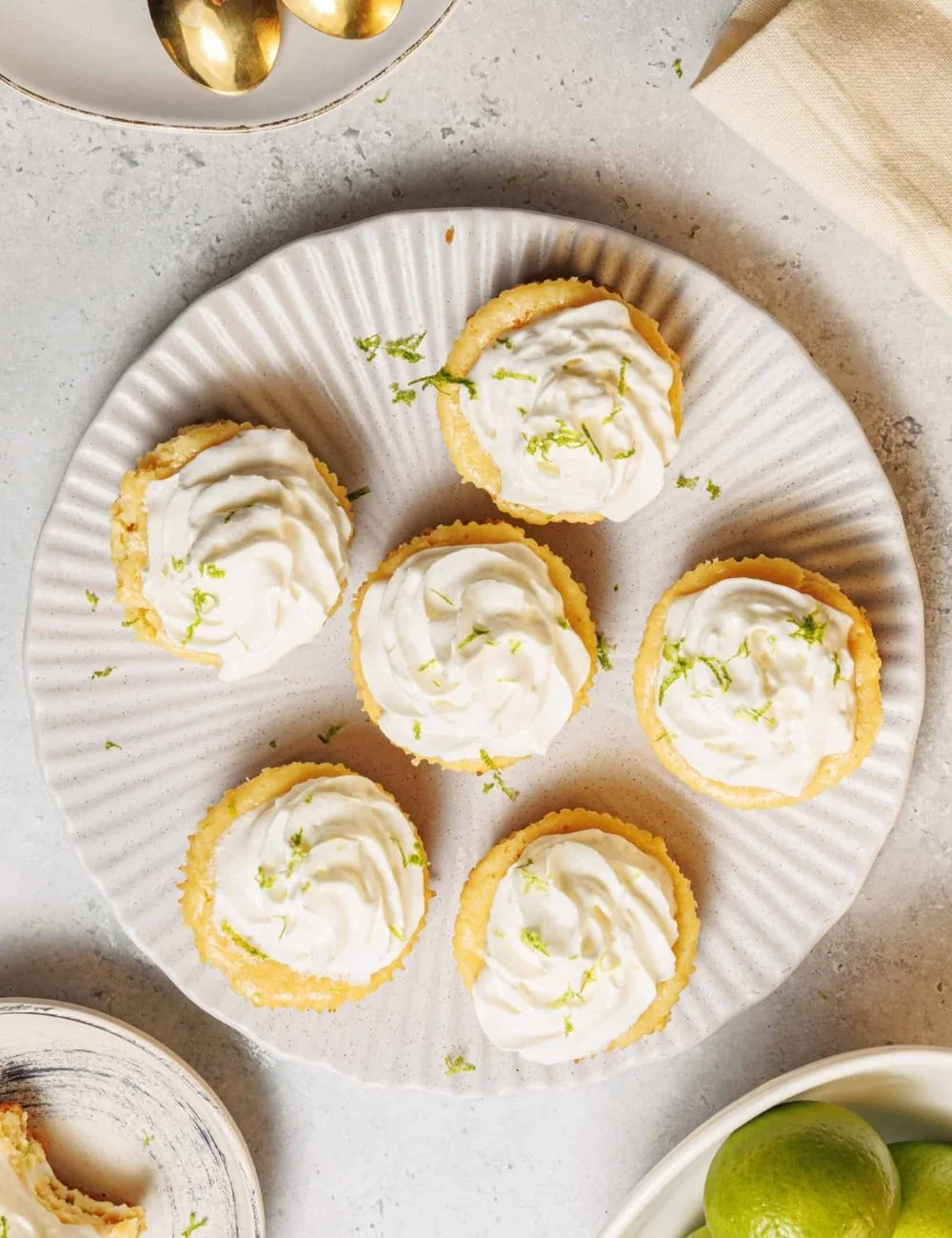 Mini key lime pies with a graham cracker crust and lime garnish
