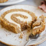 A delicious homemade pumpkin roll dessert, rolled with creamy filling.