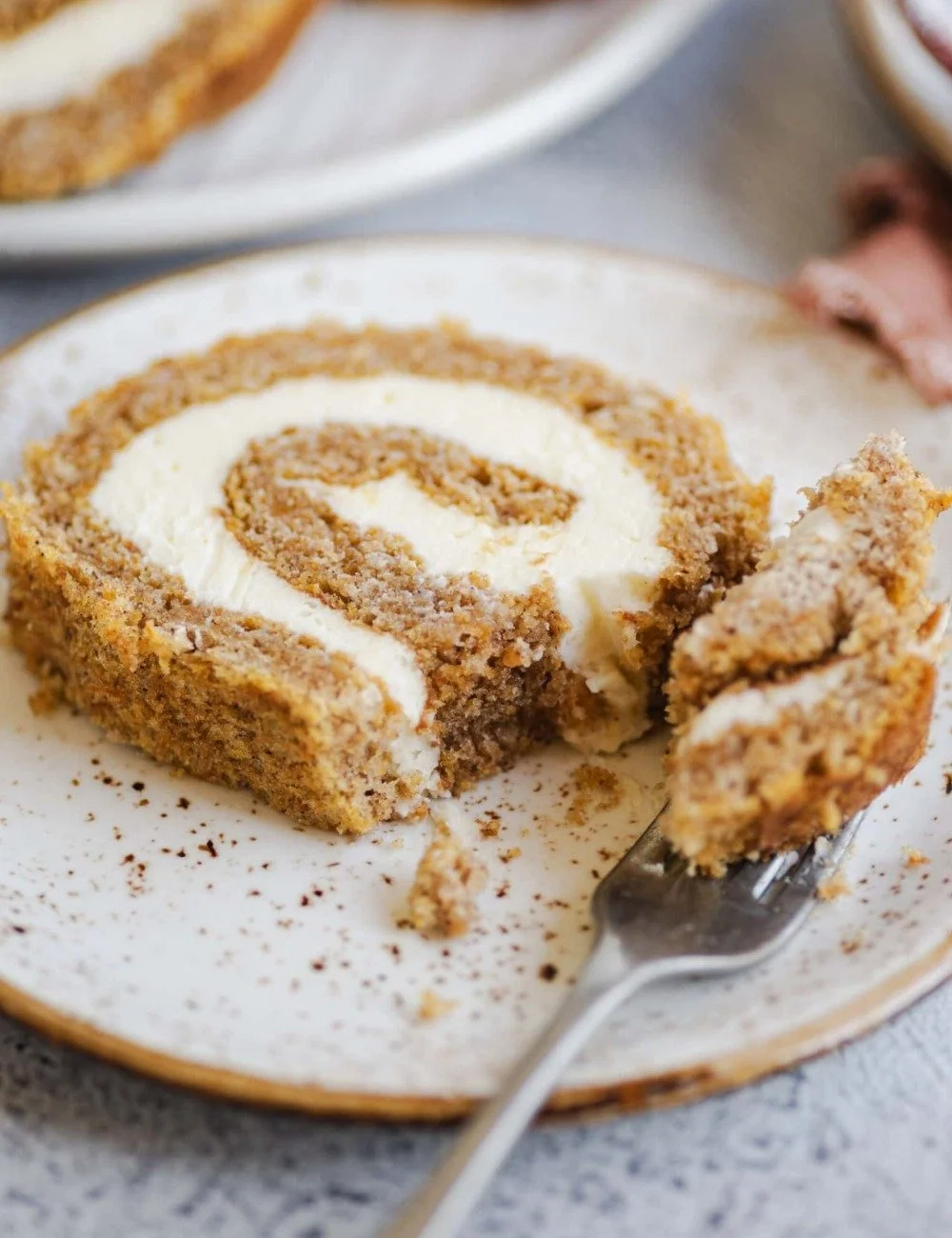 A delicious homemade pumpkin roll dessert, rolled with creamy filling.