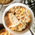 Bowl of slow cooker chicken pot pie soup with vegetables and chicken
