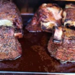 Deliciously smoked beef short ribs on a grill, ready for serving.