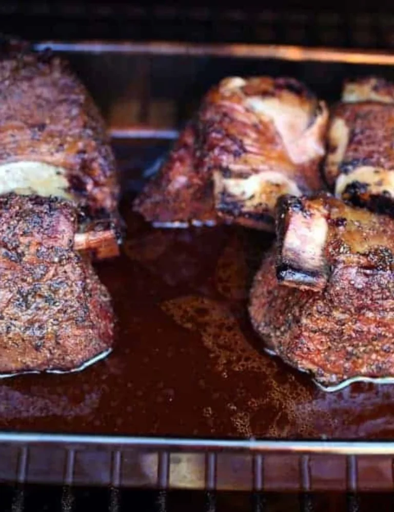 Deliciously smoked beef short ribs on a grill, ready for serving.