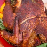 Delicious smoked turkey prepared on a grill with herbs and spices
