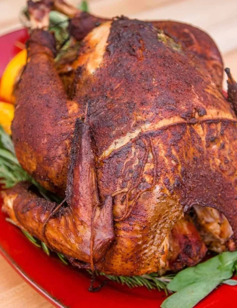 Delicious smoked turkey prepared on a grill with herbs and spices