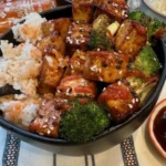 Spicy Sriracha Tofu Bowls garnished with fresh vegetables and herbs