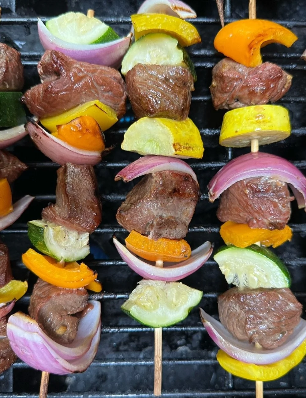 Delicious grilled steak kabobs with vegetables on skewers