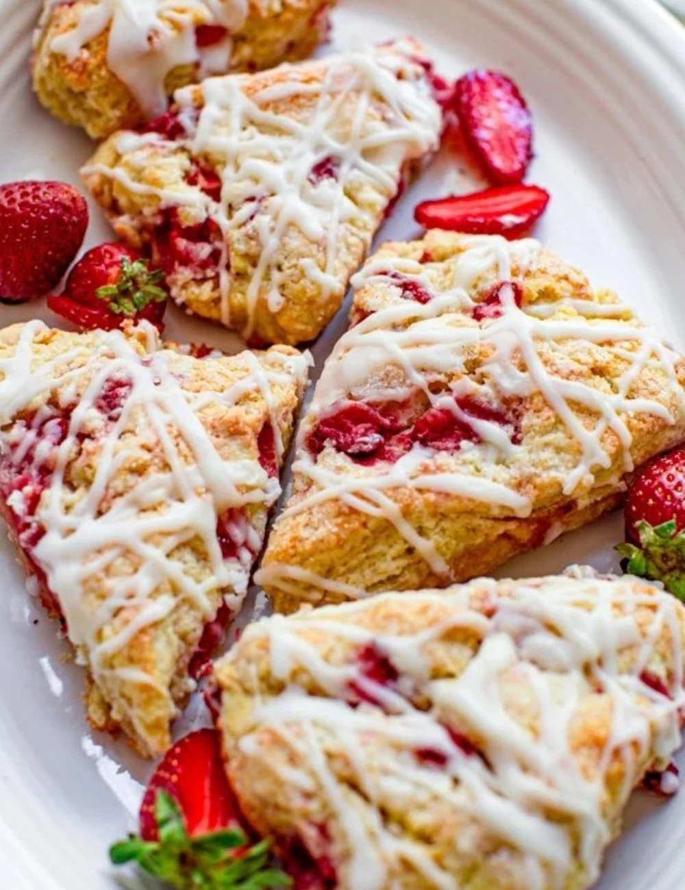 Delicious homemade strawberry cheesecake scones with fresh strawberries and cream